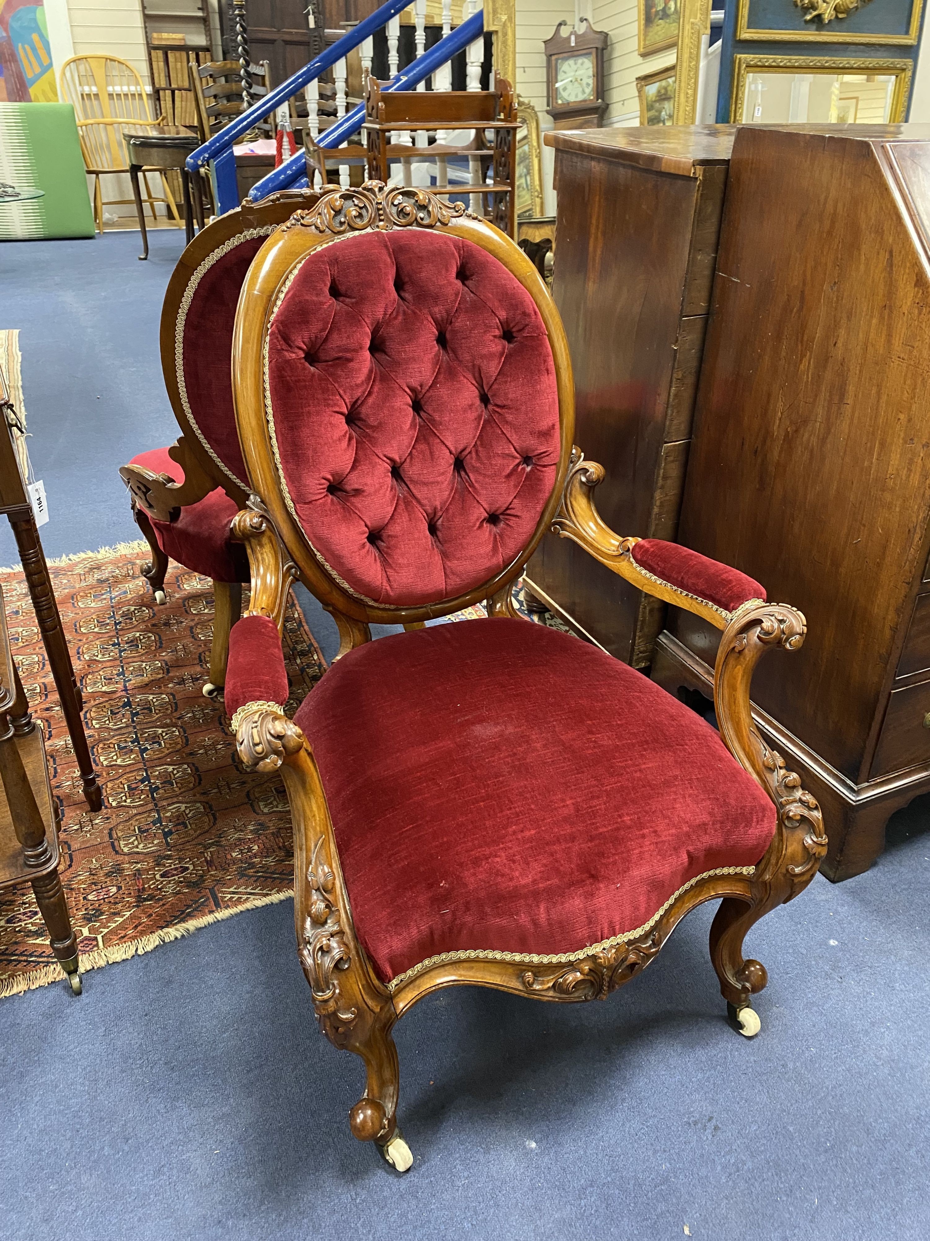 A Victorian carved walnut armchair and matching nursing chair